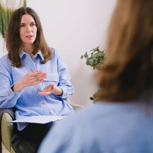 Health & Wellbeing Coach in a coaching session demonstrating the importance of life coaching skills in collaborative approach for health outcomes