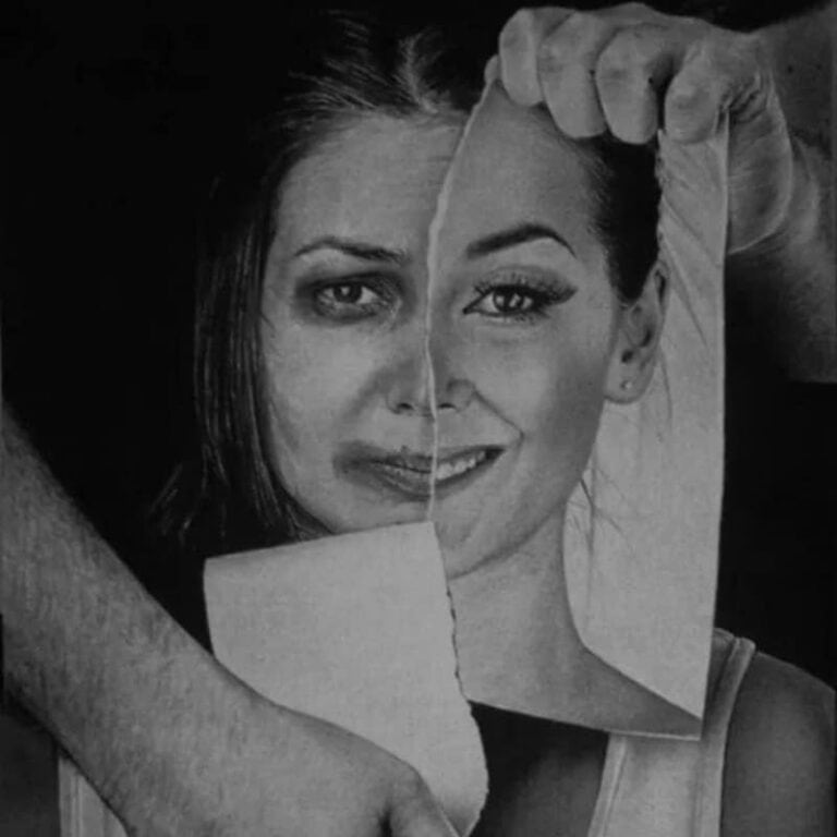 Artistic photo of a woman holding a torn photo of herself, symbolizing transformation.