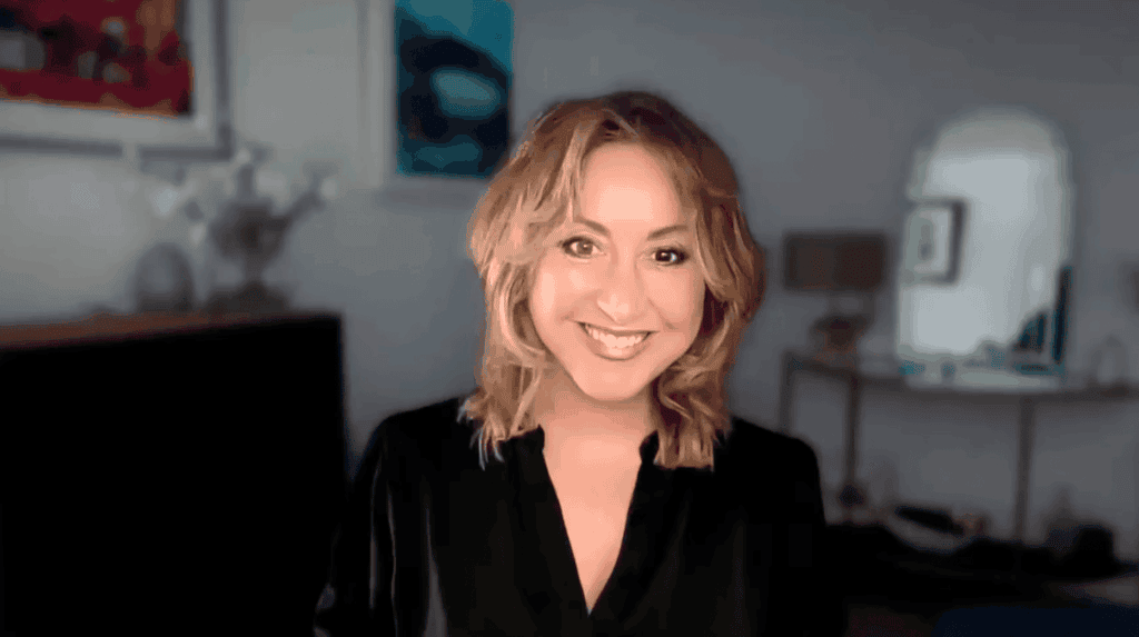 Woman smiling in a stylish home office, promoting comfort and productivity.